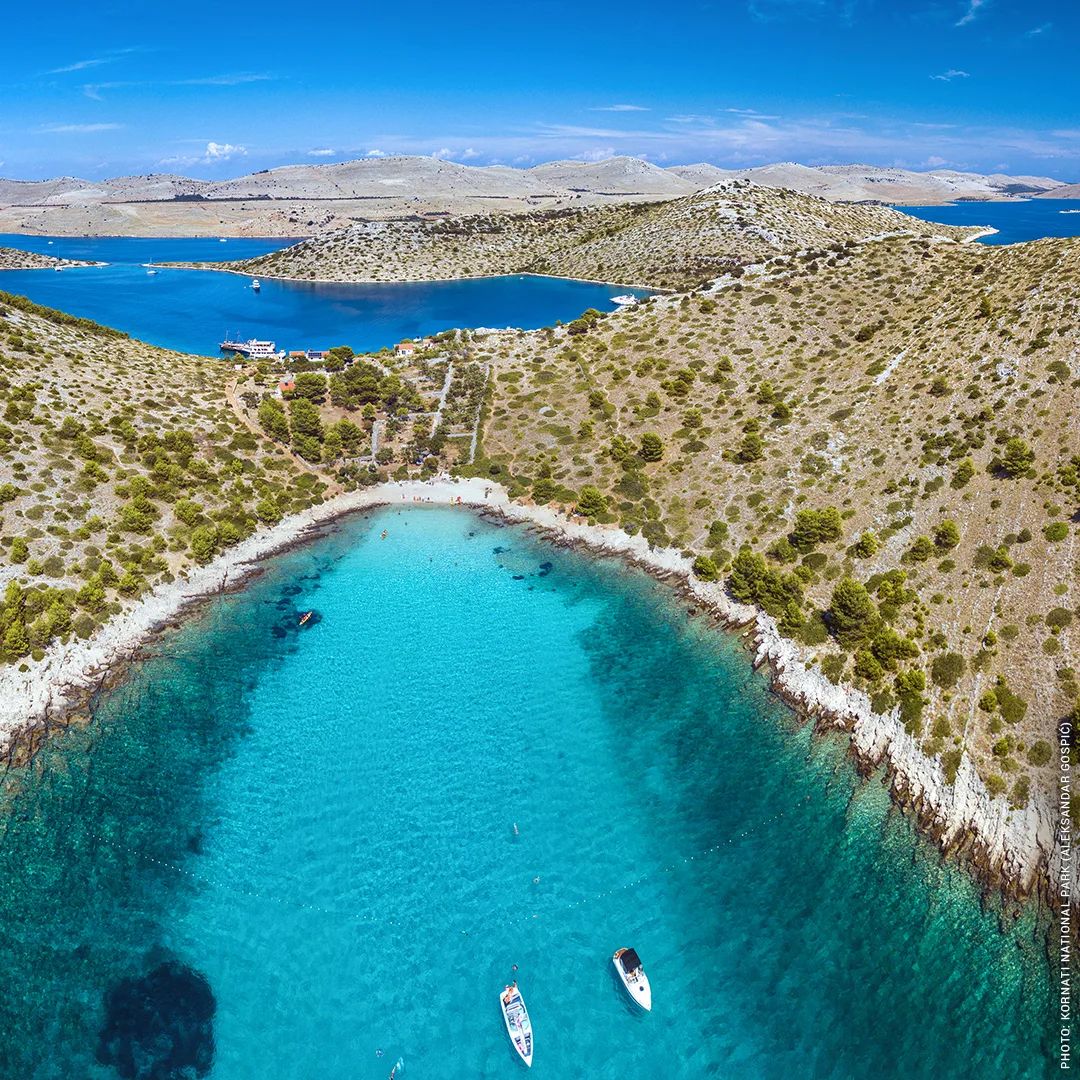 "Sailboat cruising through a crystal clear blue sea in Croatia"