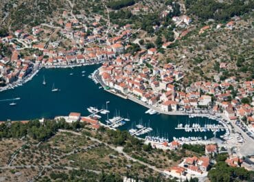 RYA Sailing School Powerboat Courses - An aerial photo of a coastal town with a harbor. Milna, Brac Island. Croatia