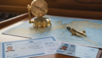 Yachting career. Two nautical certificates, one from the RYA and one from IYT, placed side-by-side on a yacht's chart table with a compass for a yachting career.
